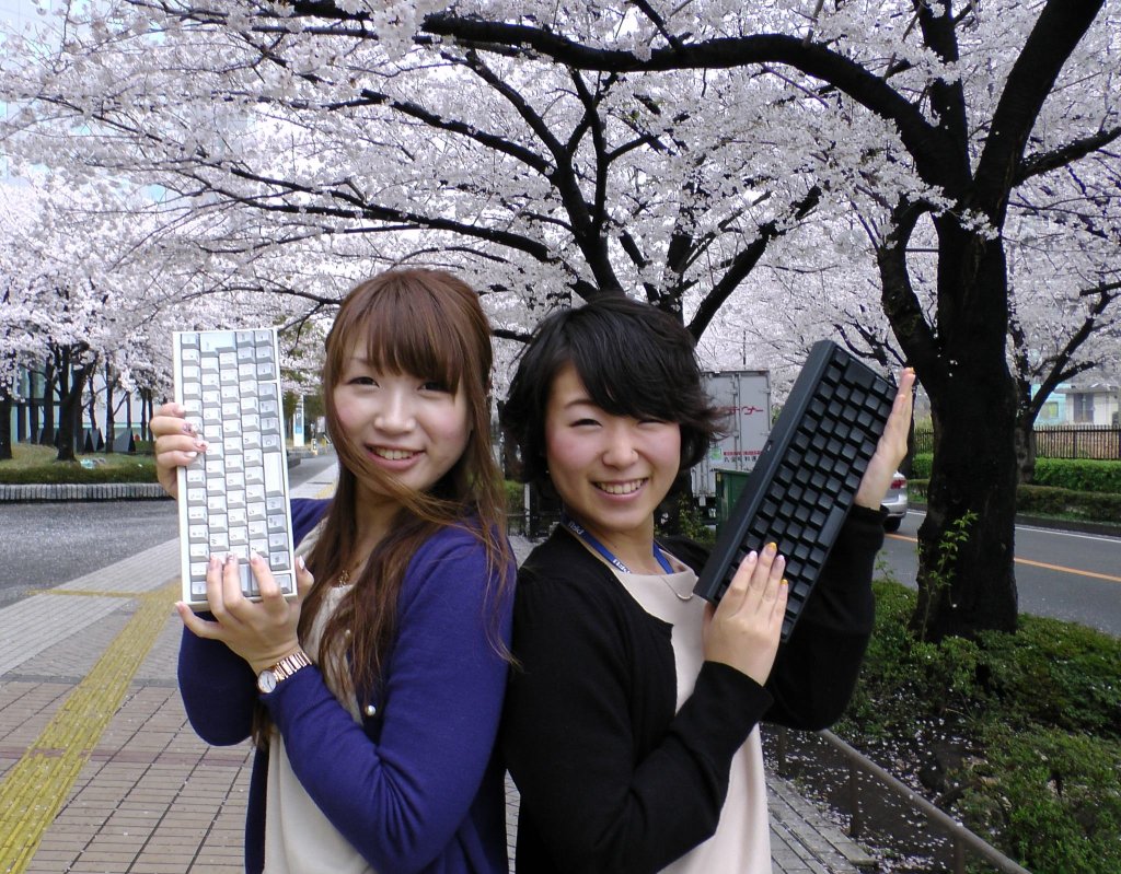 girls holding Happy Hacking Keyboard Japan